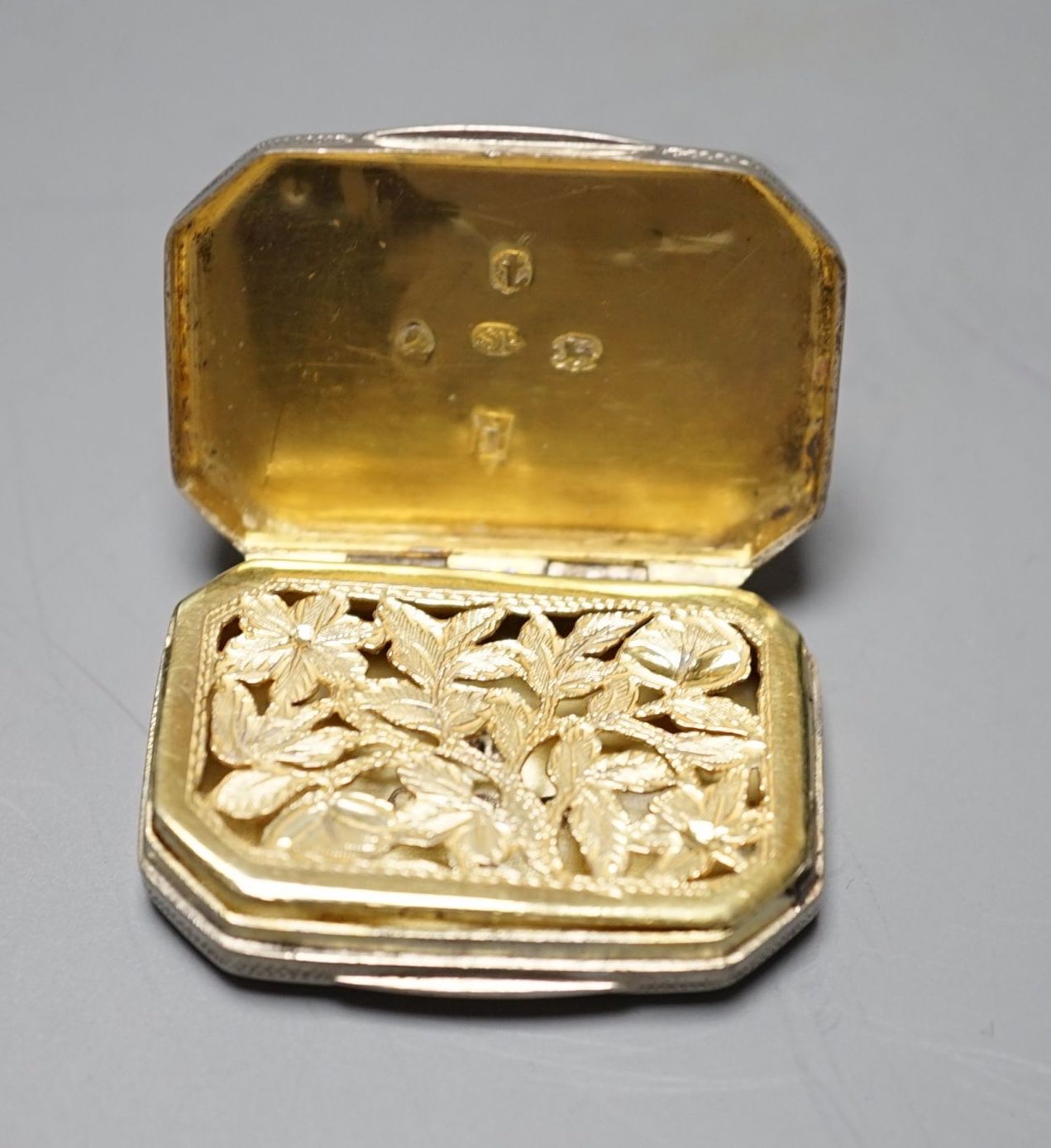 A George III engraved silver octagonal vinaigrette, by Samuel Pemberton, Birmingham, 1806, 36mm.